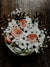 a bouquet of flowers sitting on top of a wooden table
