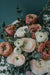 a bouquet of pink and white flowers on a table
