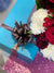 a bouquet of white and red flowers in a blue box