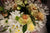 a bouquet of white and yellow flowers in a vase