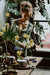 A woman arranging flowers in a vase on a table