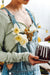 A woman holding a cake with flowers on it