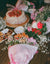 A table topped with a cake covered in flowers